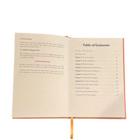 Open pages of The Aligned Journal - Guided Journal for Personal Realignment showing the table of contents with structured prompts for self-discovery.